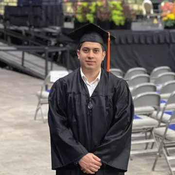 Headshot of Manuel Diaz wearing a cap and gown.